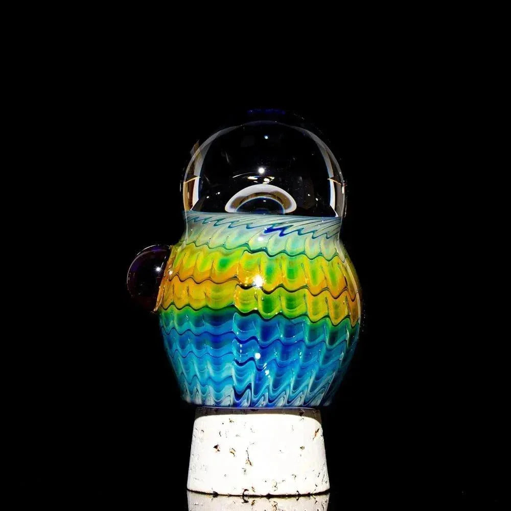 Mini glass jar with cobalt, blue, yellow, and green wavy patterns on black background