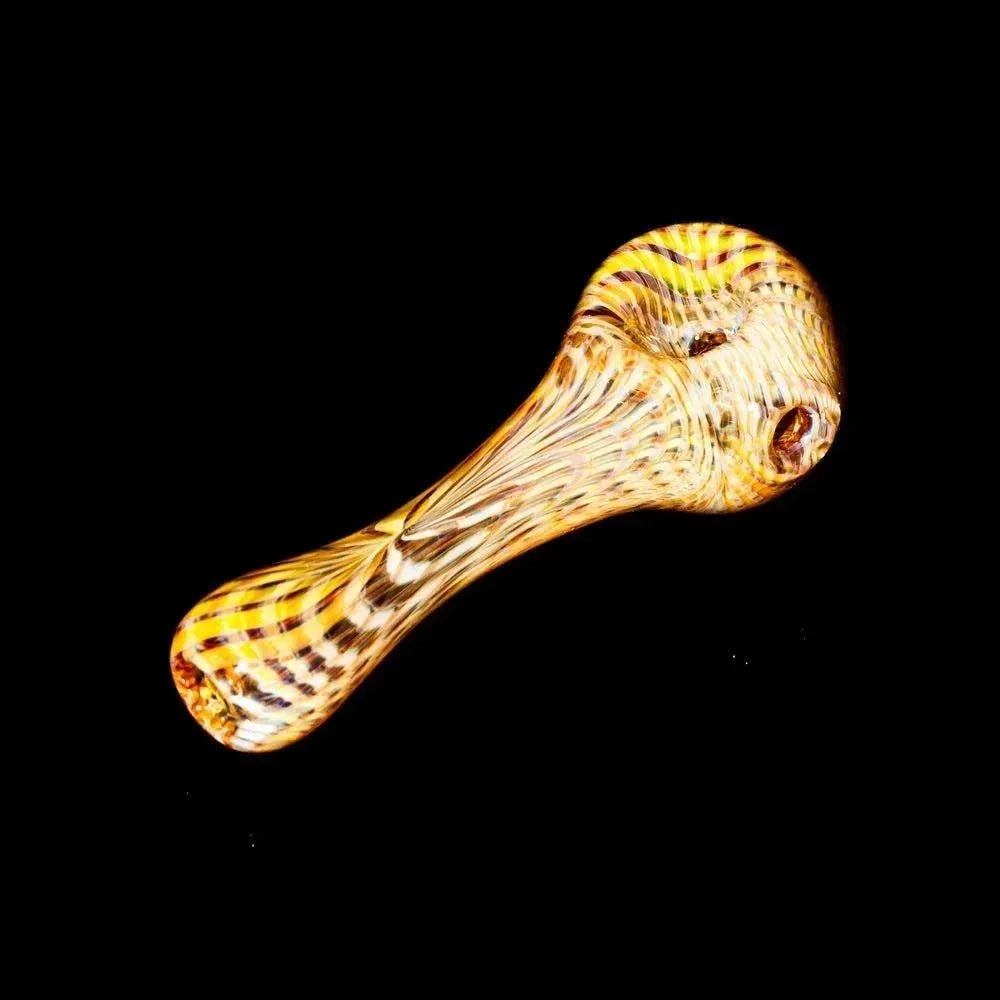 Yellow glass hand pipe with retti pattern on black background