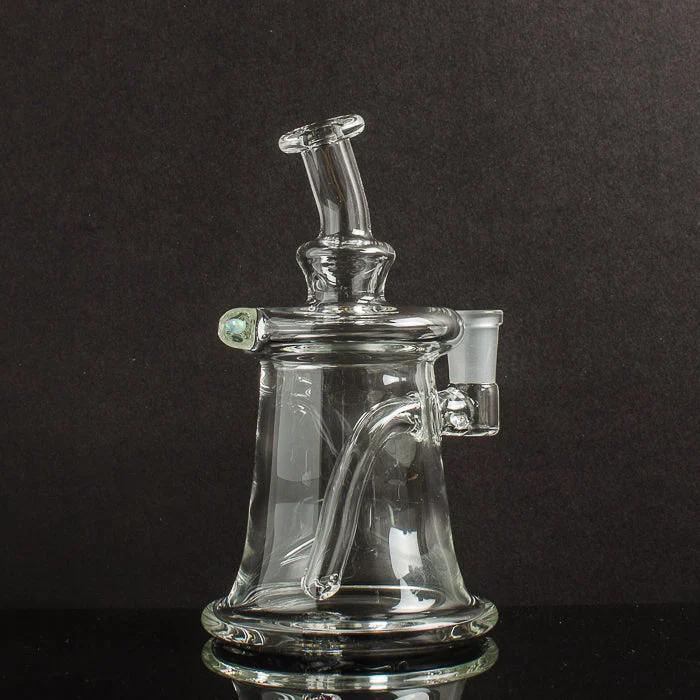 Clear glass dab rig with recycler design, curved arm, and side carb cap on black background