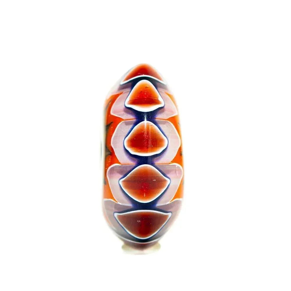 Handcrafted glass lentil bead with chartreuse, orange, and chevron pattern on white background