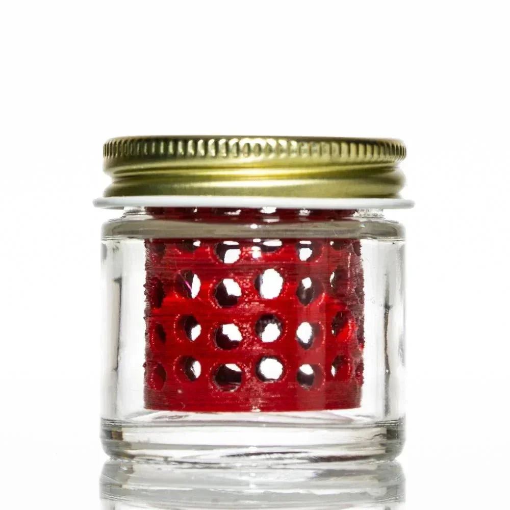 Glass jar with gold lid and red perforated insert for cleaning small glass pieces