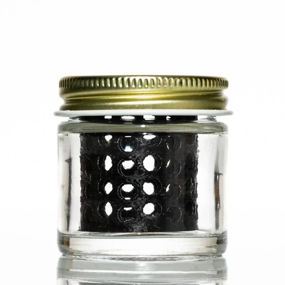 Glass jar with metal lid and black perforated filter inside for smoking accessory cleaning