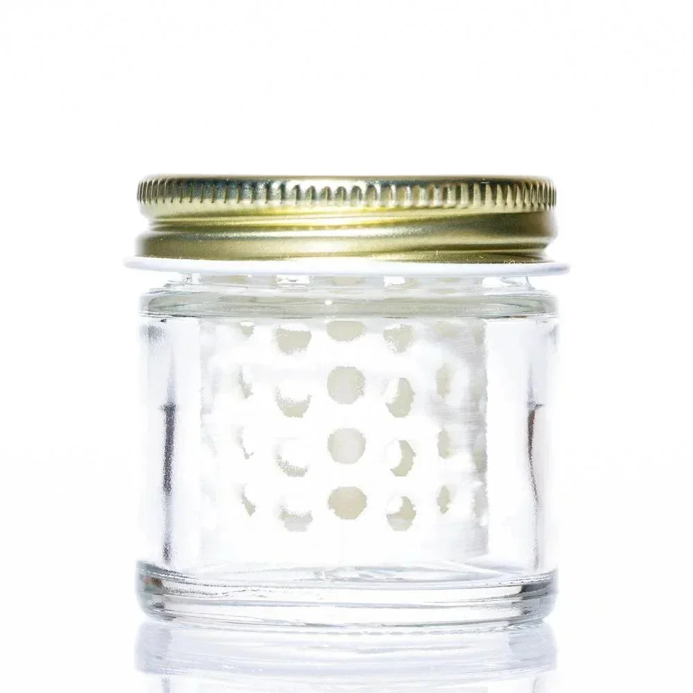 Clear glass jar with gold lid and white perforated insert, ideal for accessory storage
