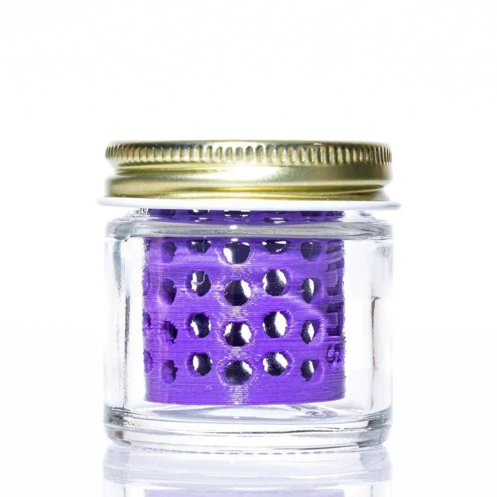 Glass storage jar with gold lid and purple perforated insert for accessories