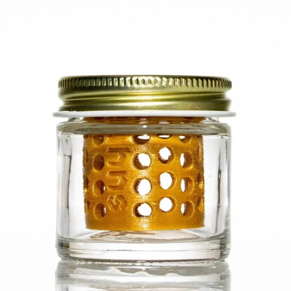 Clear glass jar with metal lid and yellow perforated insert for cleaning glass accessories