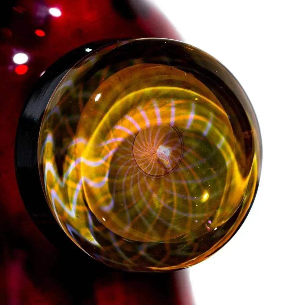 Close-up of a fumed glass detail with spiral patterns on a red glass piece