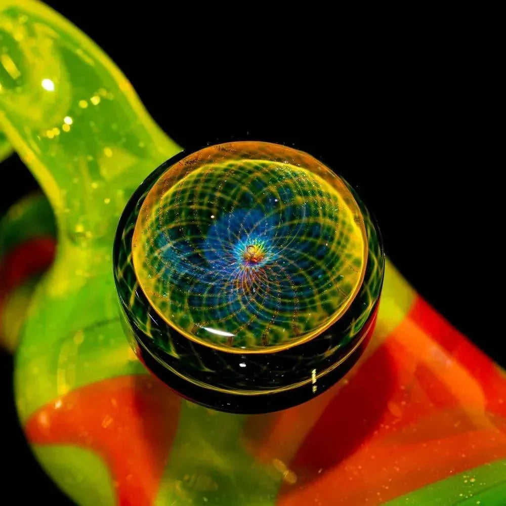 Close-up of colorful heady glass pipe with intricate spiral design on dome