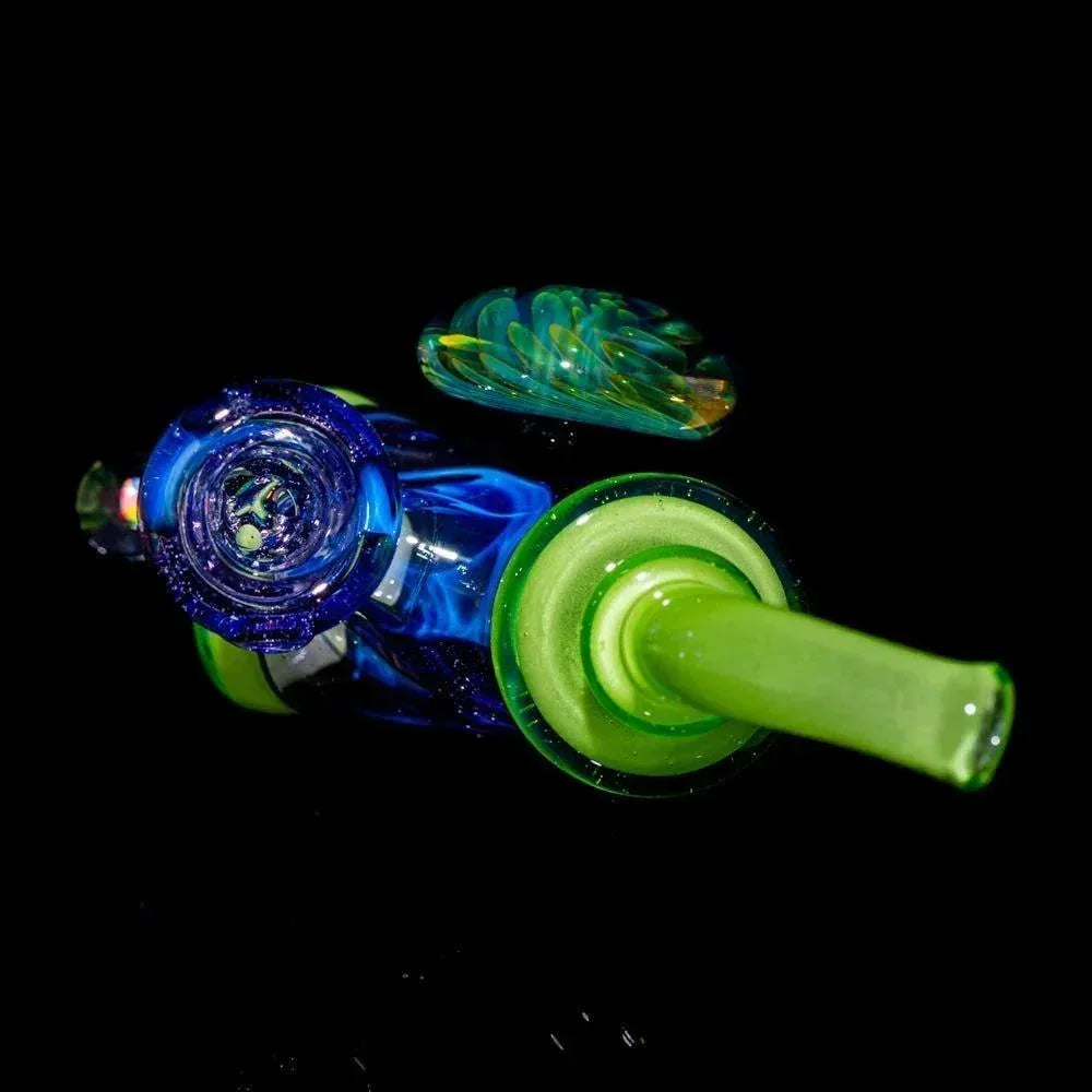 Colorful glass hand pipe with lime green, blue, and purple accents on black background