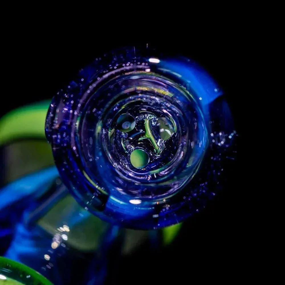 Close-up of intricate blue and lime green glass pipe mouthpiece with swirling details