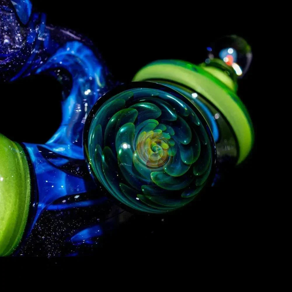 Hand-blown glass pipe with intricate blue, green, and lime glasswork on black background