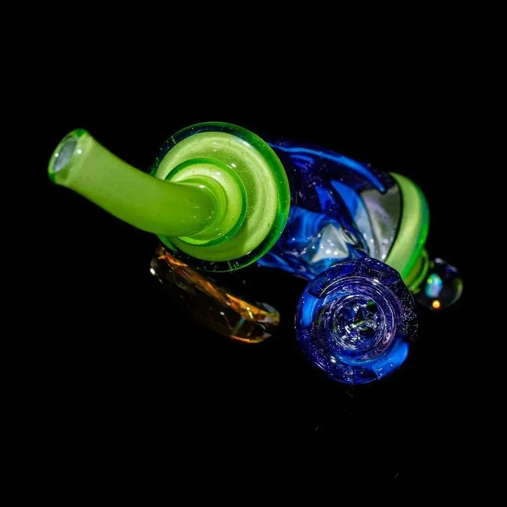 Colorful glass hand pipe with lime green and blue accents on black background