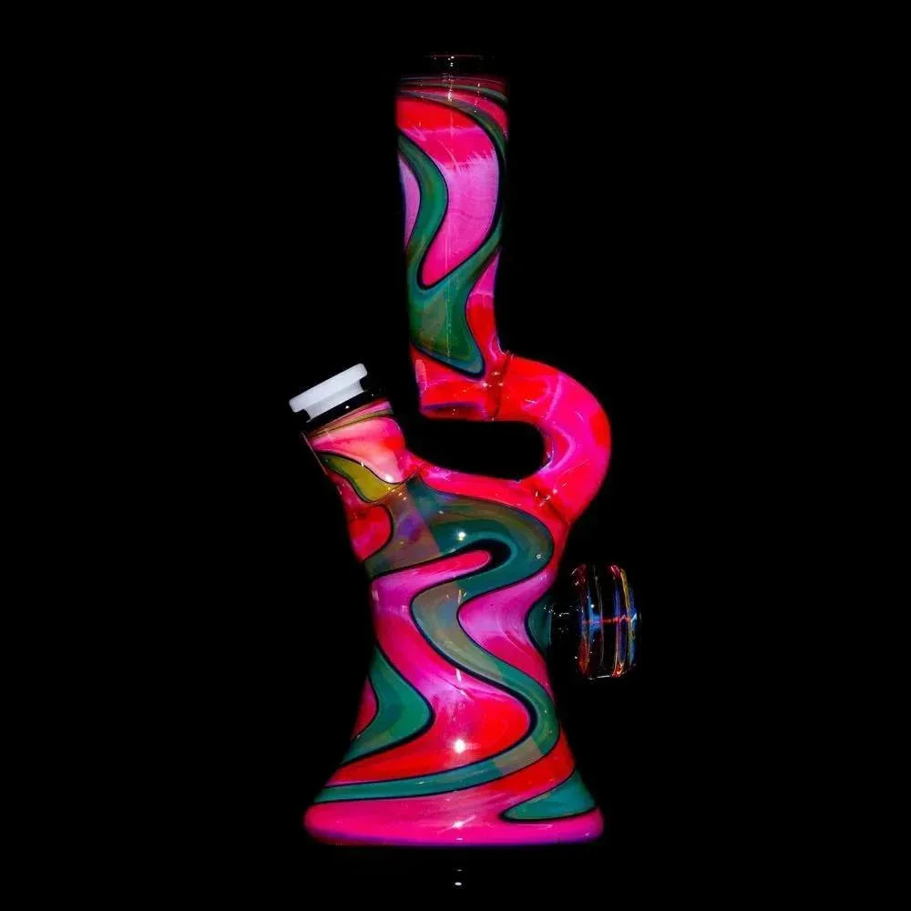 Colorful glass water pipe with pink, green, and lava swirl patterns on black background