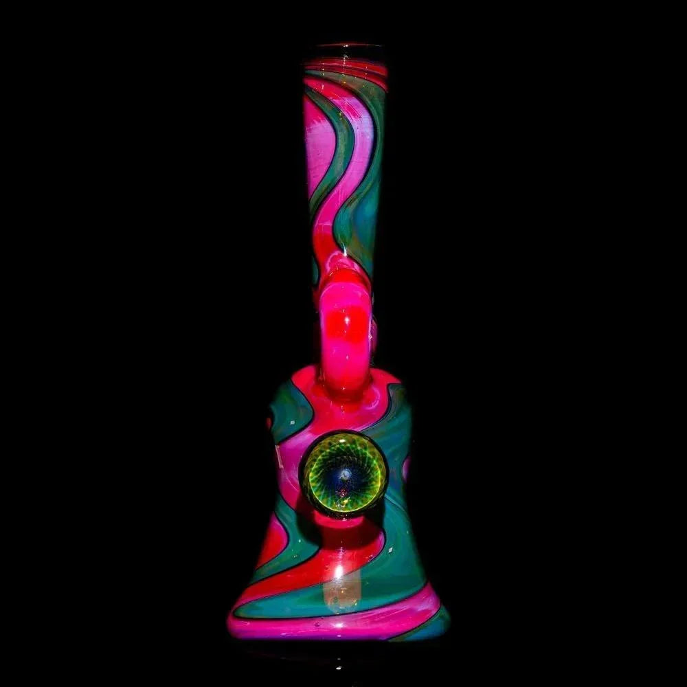 Handblown glass water pipe with pink, green, and teal swirls and a dragon eye accent.