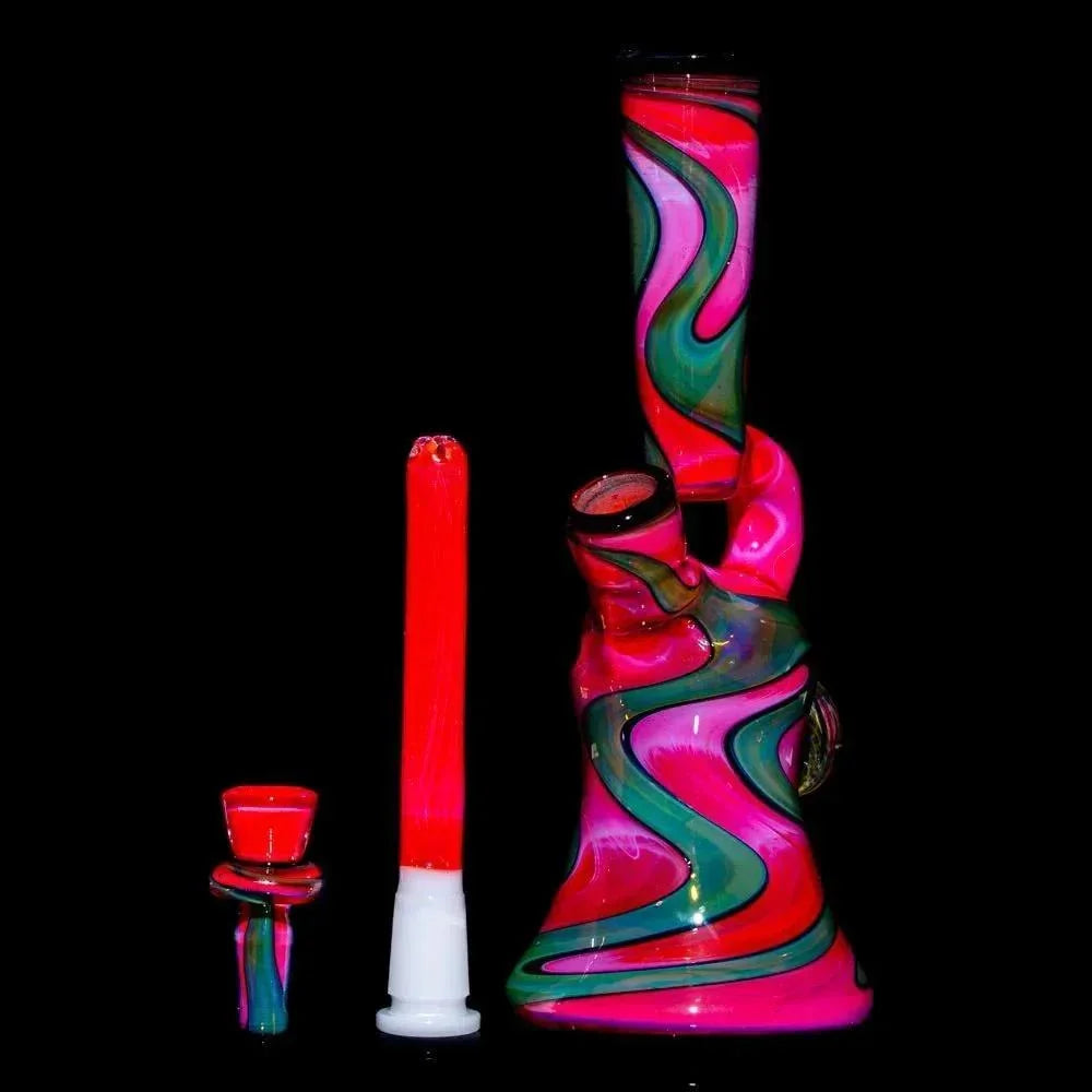 Pink, green, and red glass water pipe with matching bowl and downstem on black background