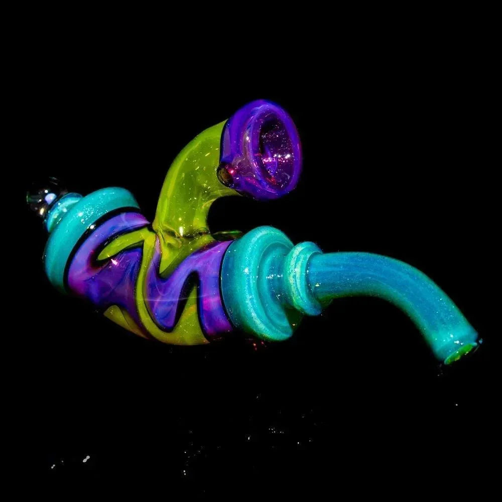Colorful hand-blown glass pipe with blue, green, and purple swirls on a black background.