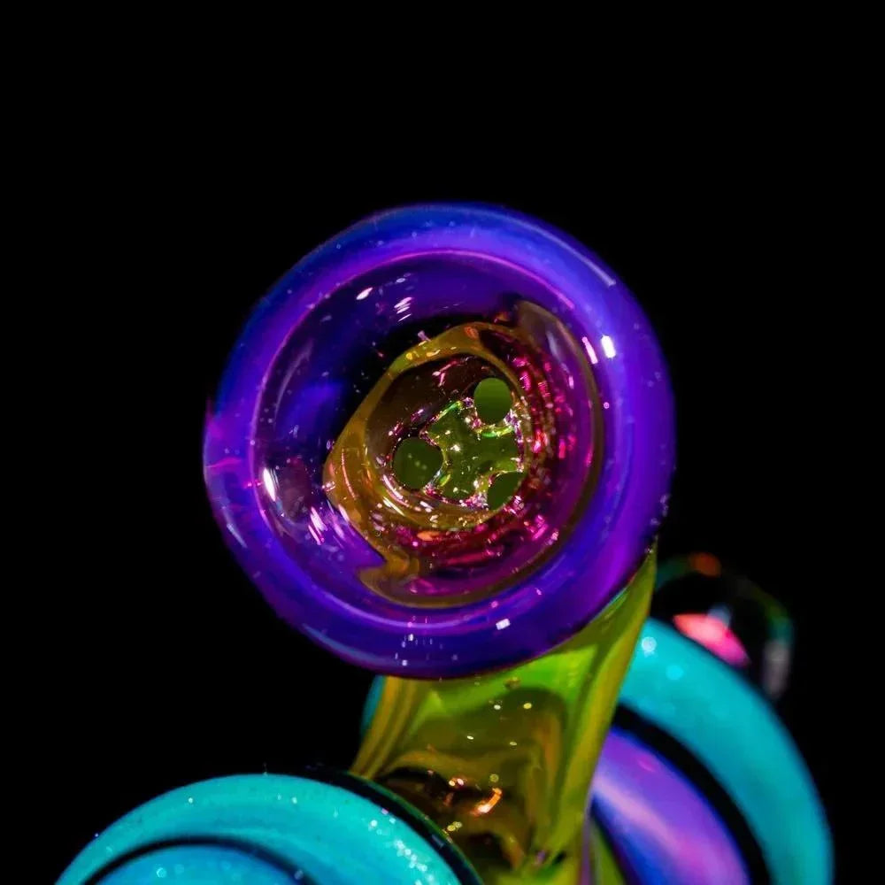 Close-up of colorful heady glass pipe with vibrant purple, blue, and green accents