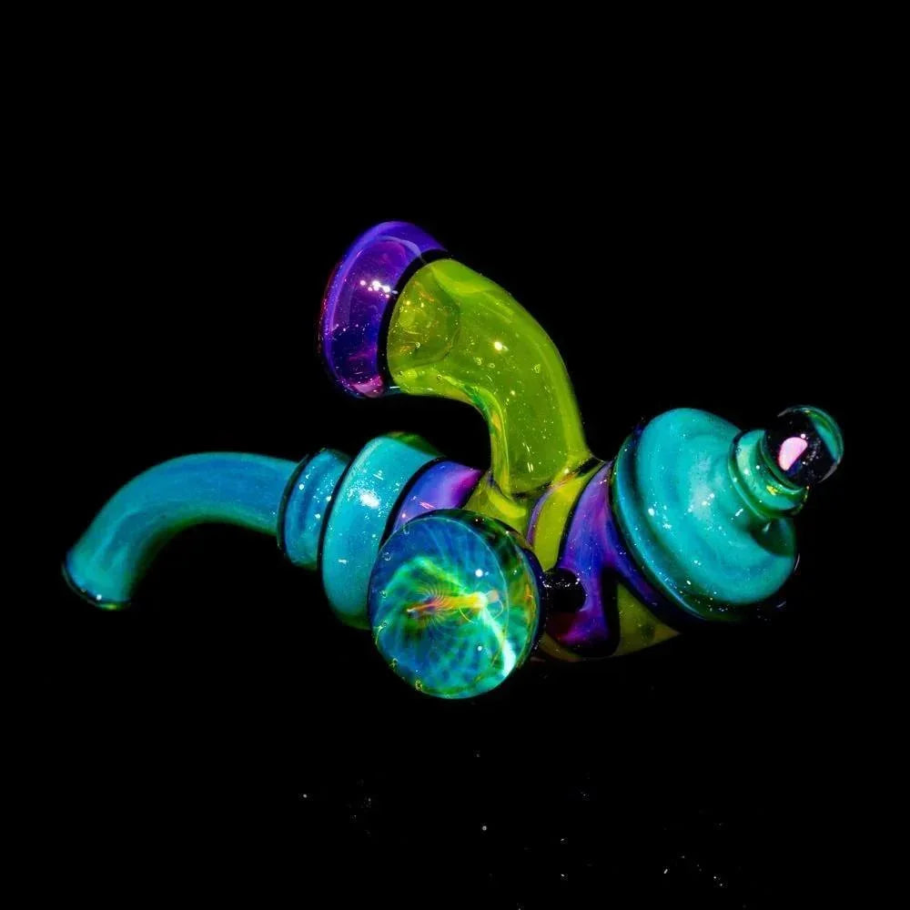 Colorful heady glass pipe with blue, green, and purple accents on a black background