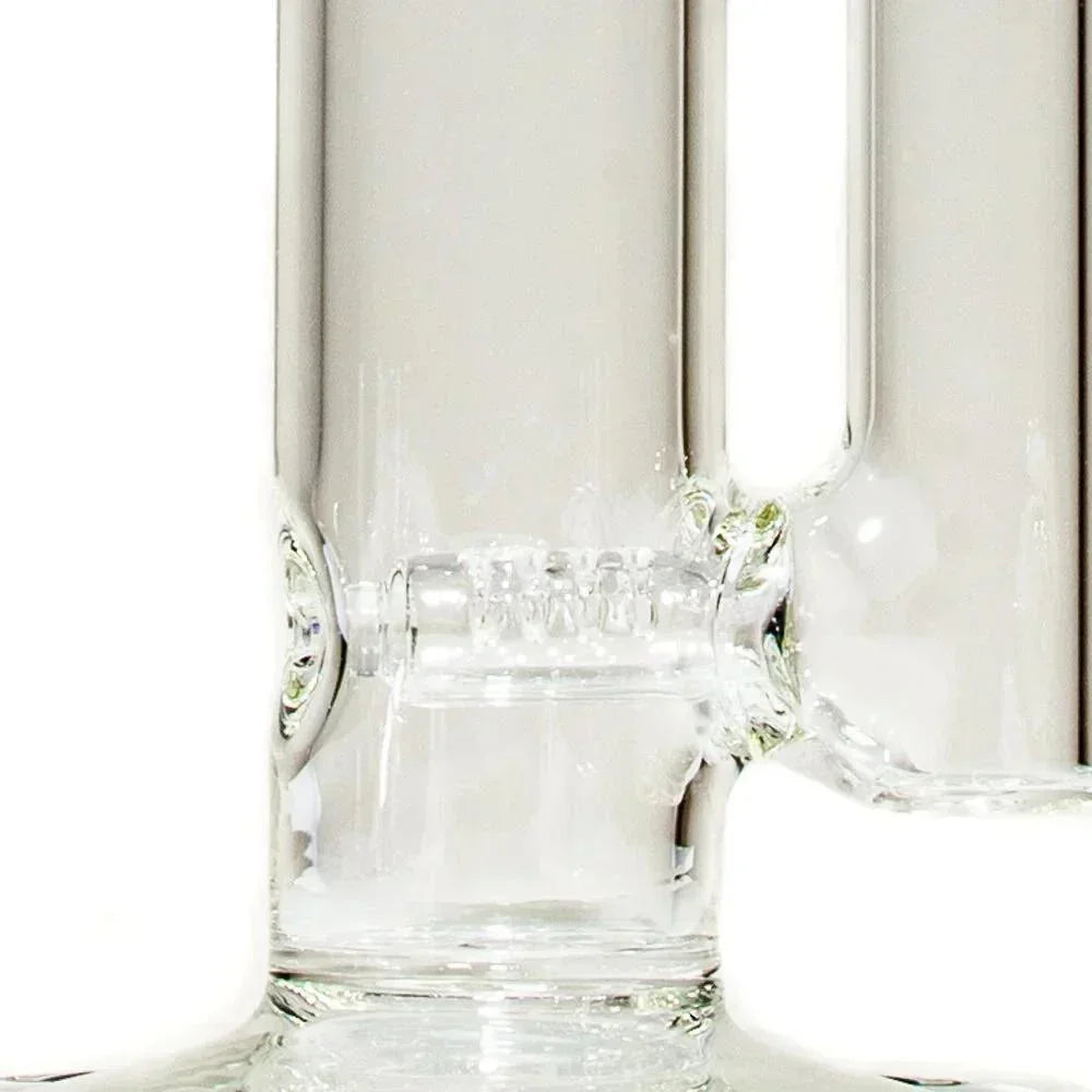 Close-up of clear glass tube with gridline perc, smoking accessory detail.