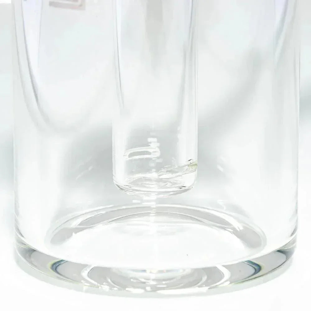 Close-up of a clear glass water pipe chamber with cylindrical downstem.