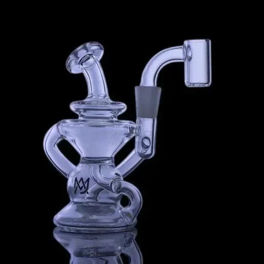 Clear glass recycler dab rig with bent neck and quartz banger on black background