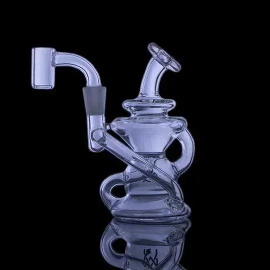 Clear glass recycler dab rig with spiral tubing on black background