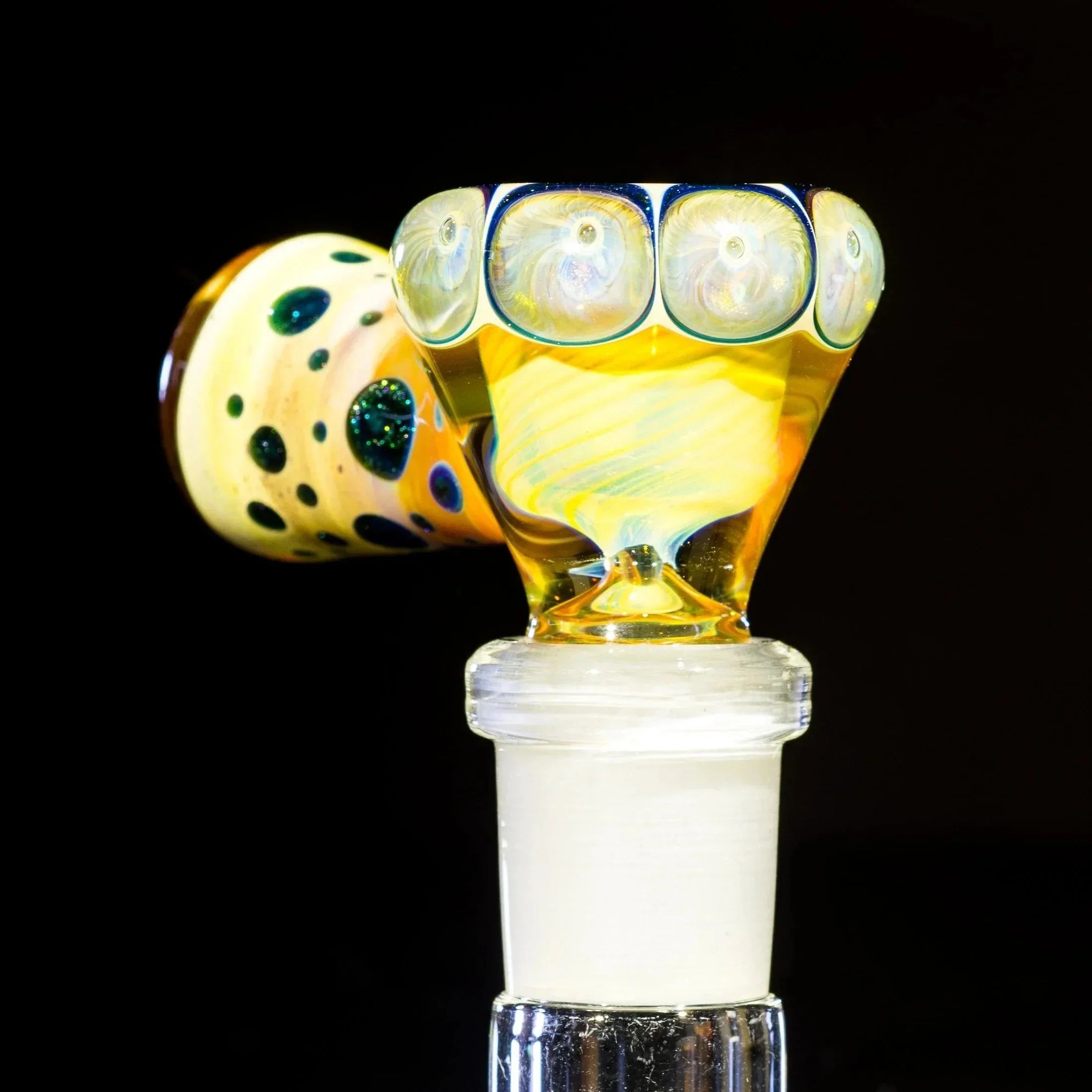 Colorful glass bowl slide with intricate caramel and vortex patterns, 14mm fitting, on black background