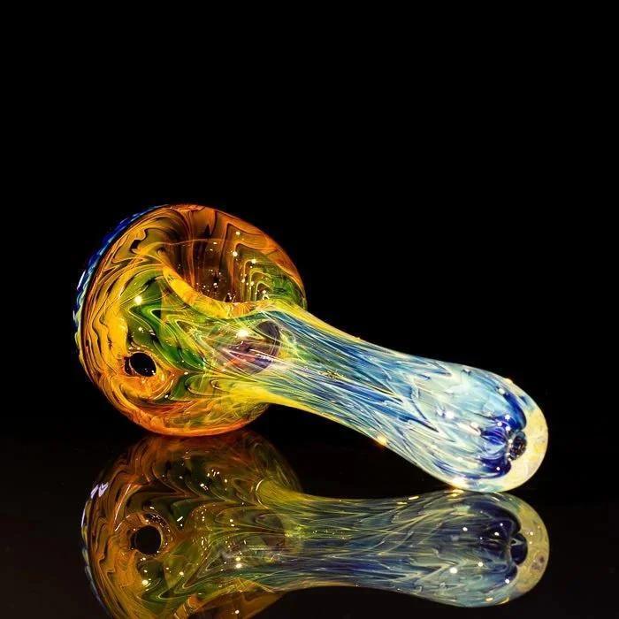 Vibrant rainbow glass pipe with swirling colors, reflective surface, heady glass art piece