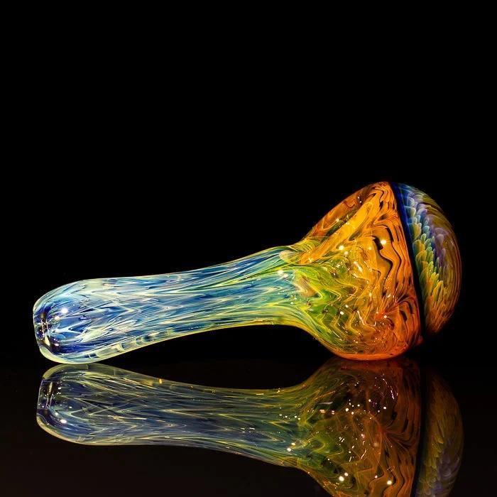 Vibrant rainbow glass pipe with swirling colors, reflective surface, heady glass art piece