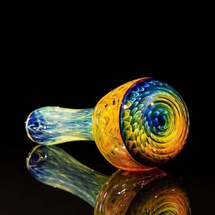 Vibrant rainbow swirl glass pipe with blue stem, reflective surface, heady glass art