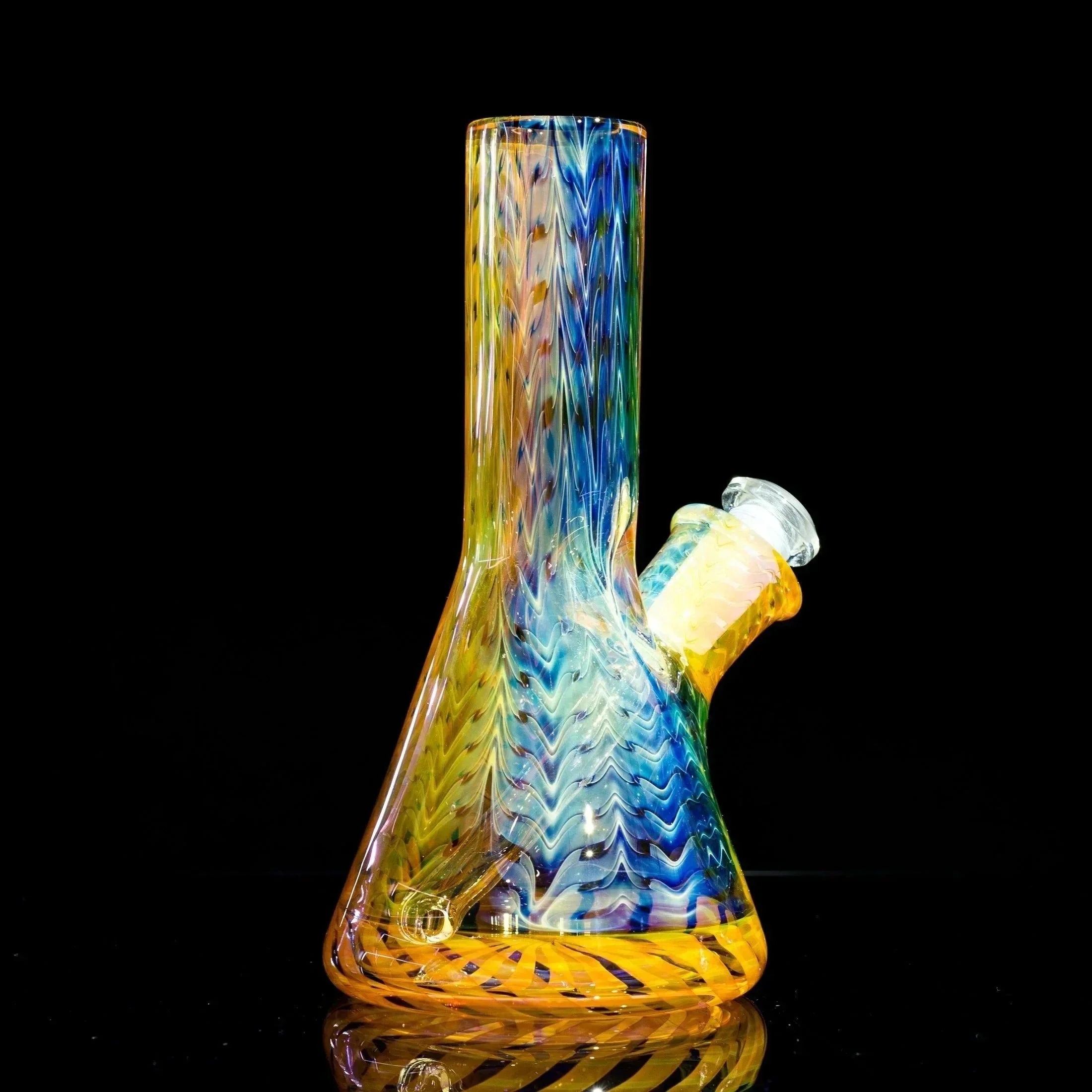 Colorful glass bong with rainbow swirls and chevron patterns, heady glass art piece