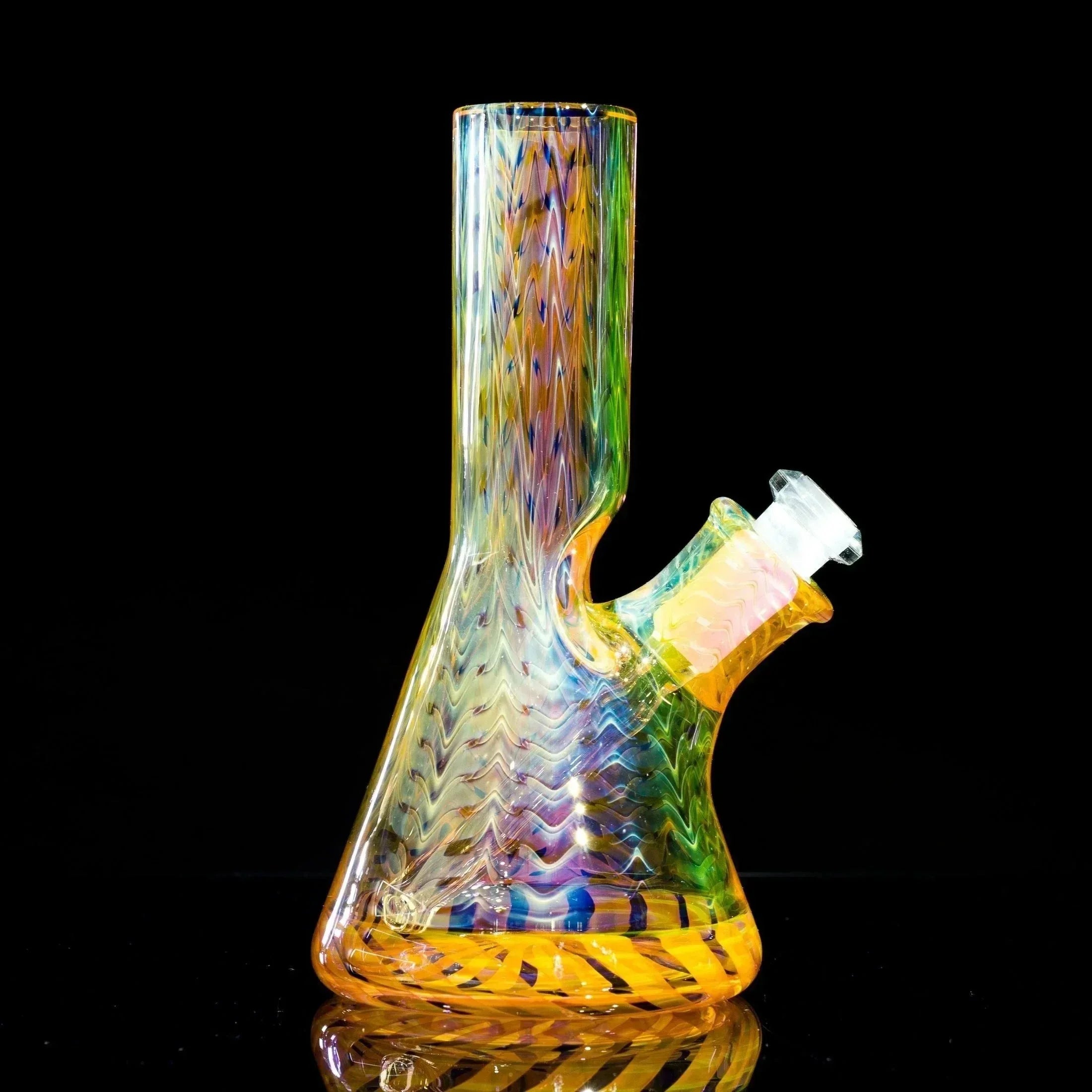 Vibrant rainbow glass bong with wavy patterns and clear downstem, showcasing heady glass artistry.
