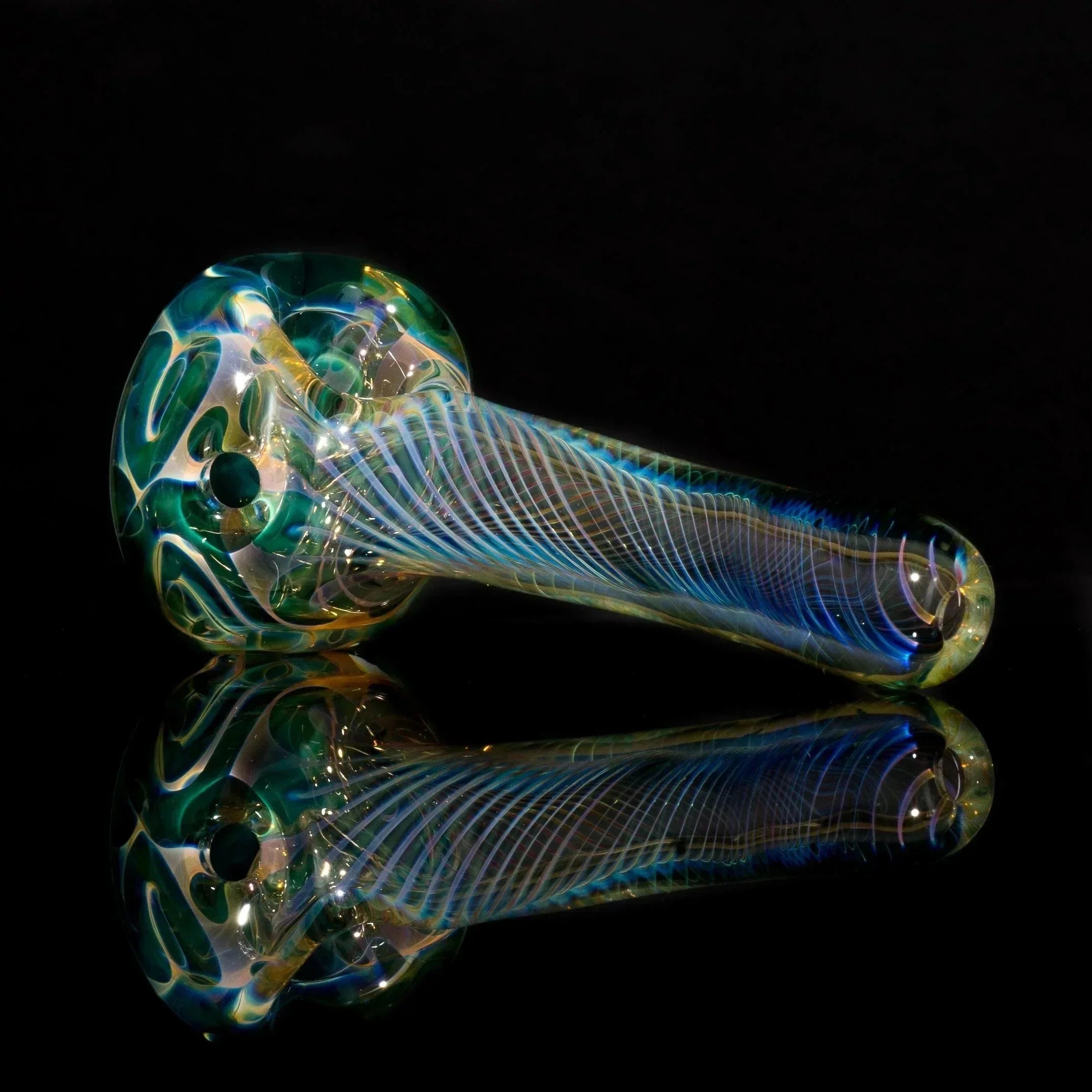 Iridescent heady glass pipe with swirls and ribbed stem, reflective surface, black background