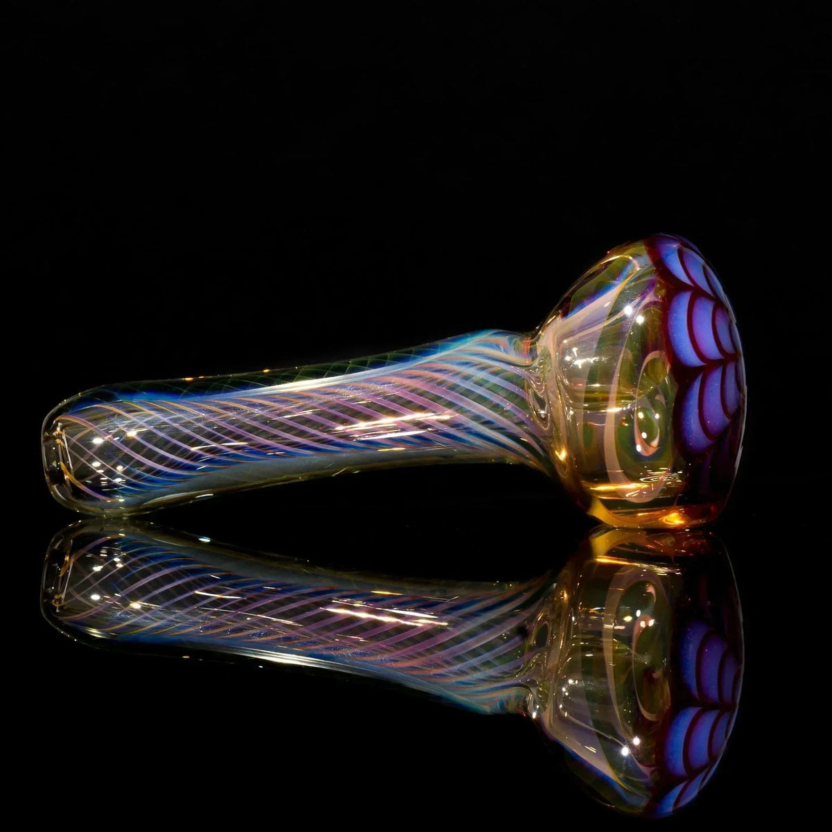 Iridescent glass pipe with purple swirls and floral bowl, reflective surface, black background