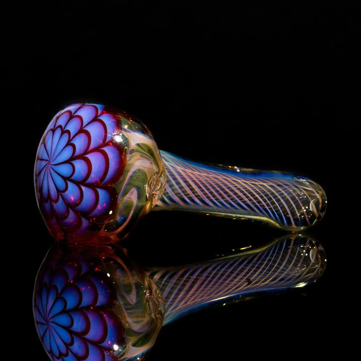 Handblown glass pipe with blue floral design and rainbow swirls, reflective surface
