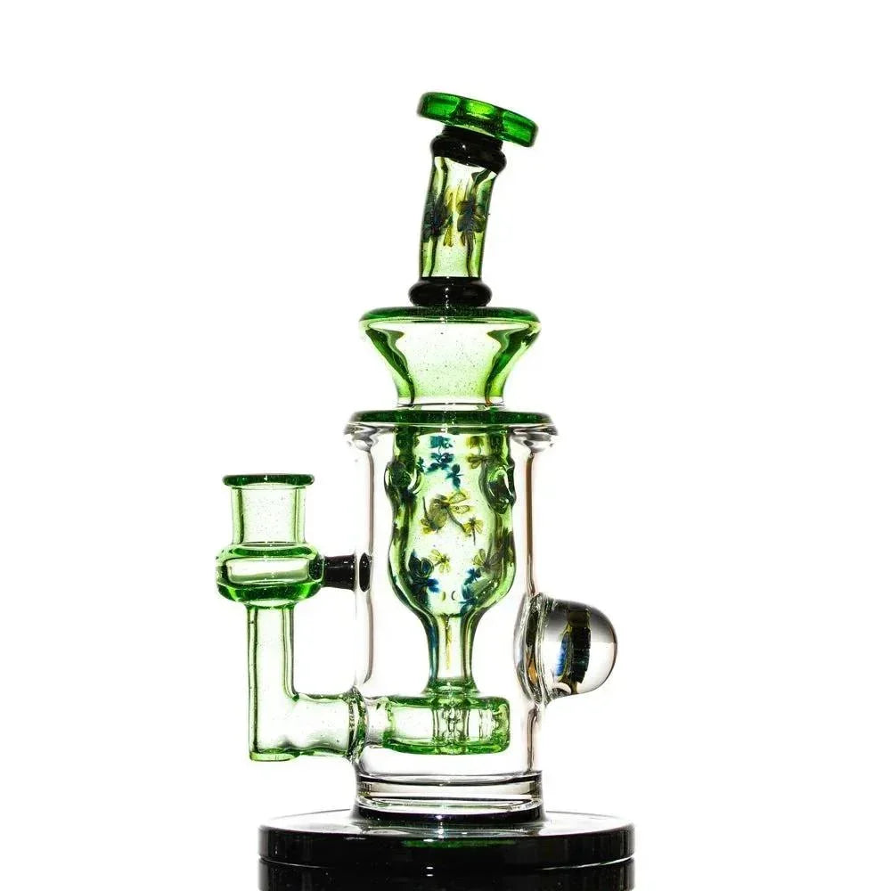 Green and clear glass water pipe with floral accents and intricate artistic details
