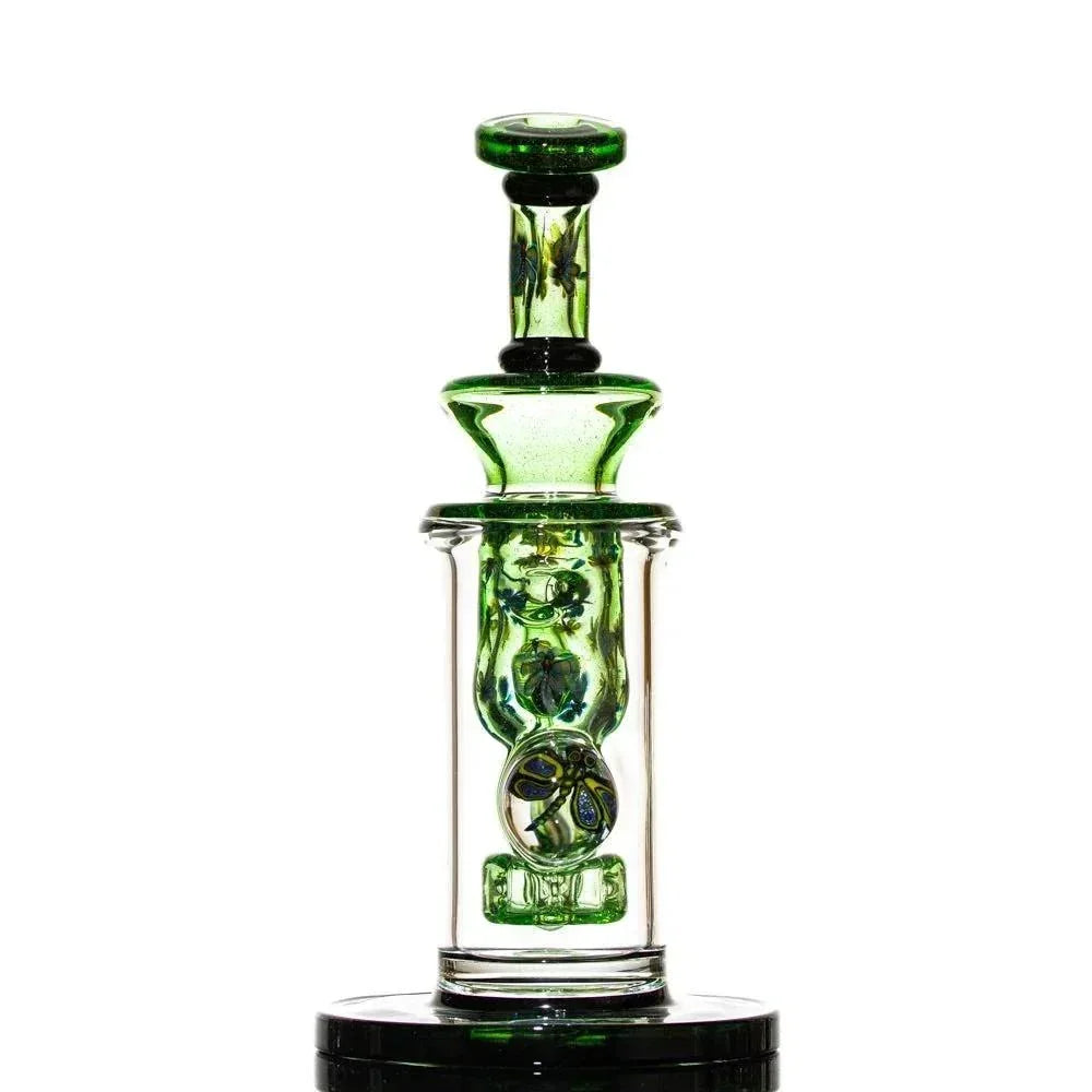 Green and clear glass water pipe with intricate design on white background