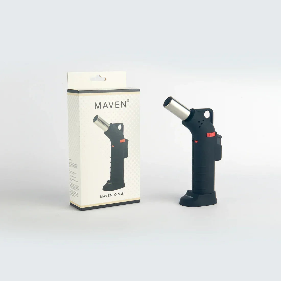 Black handheld torch lighter with silver nozzle next to its retail packaging on white background