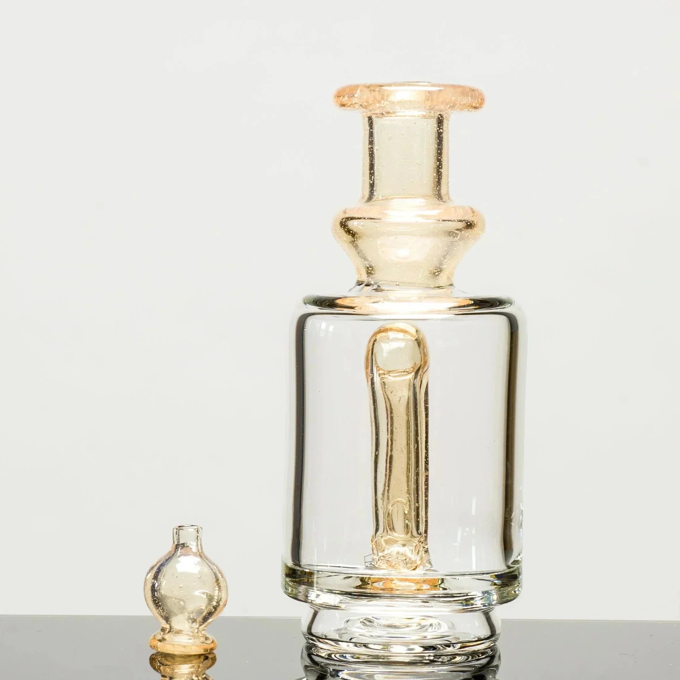 Clear glass bong with amber accents and matching bowl, featuring a sleek, modern design for smoking accessories.