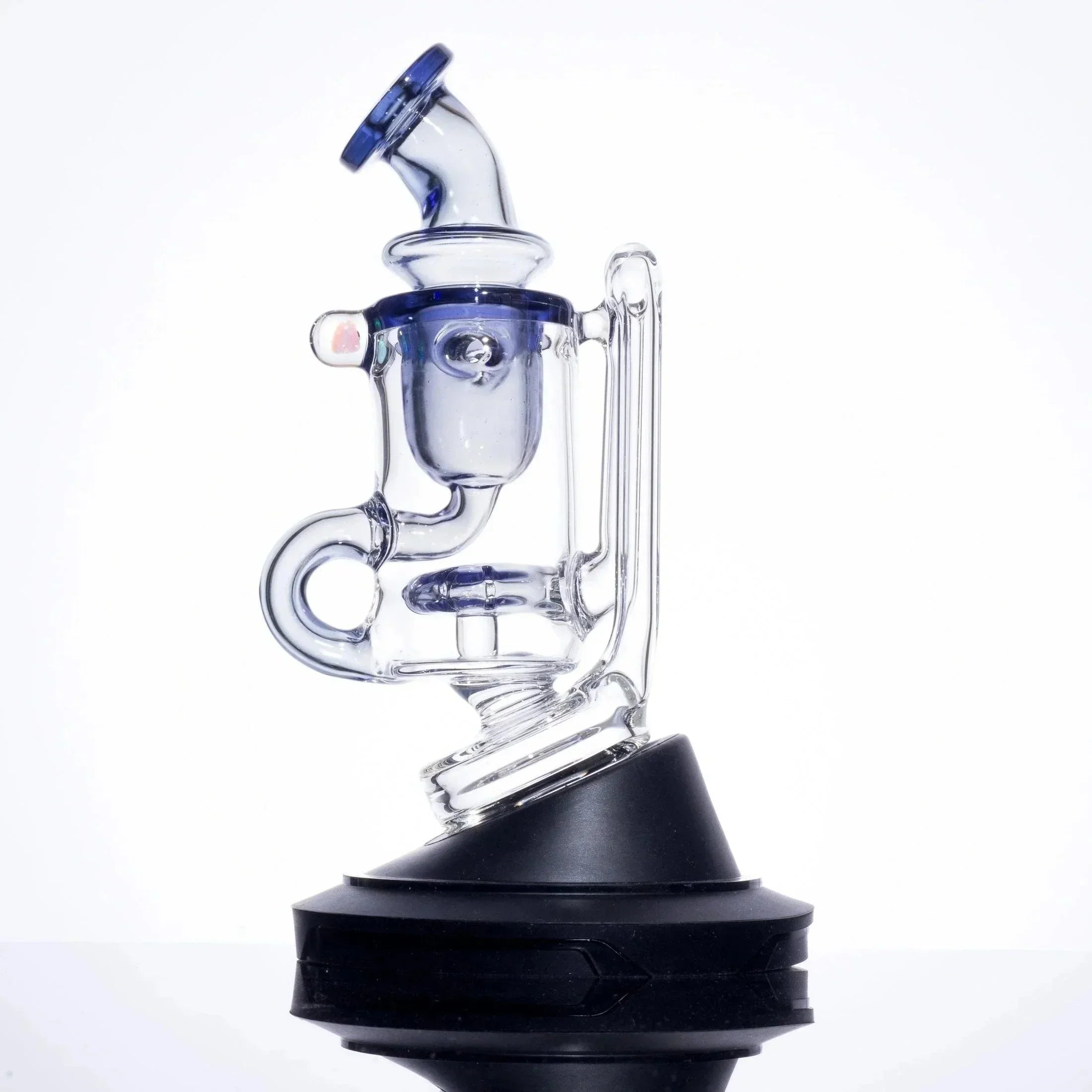 Clear glass dab rig with blue accents and black base, featuring percolator and angled mouthpiece