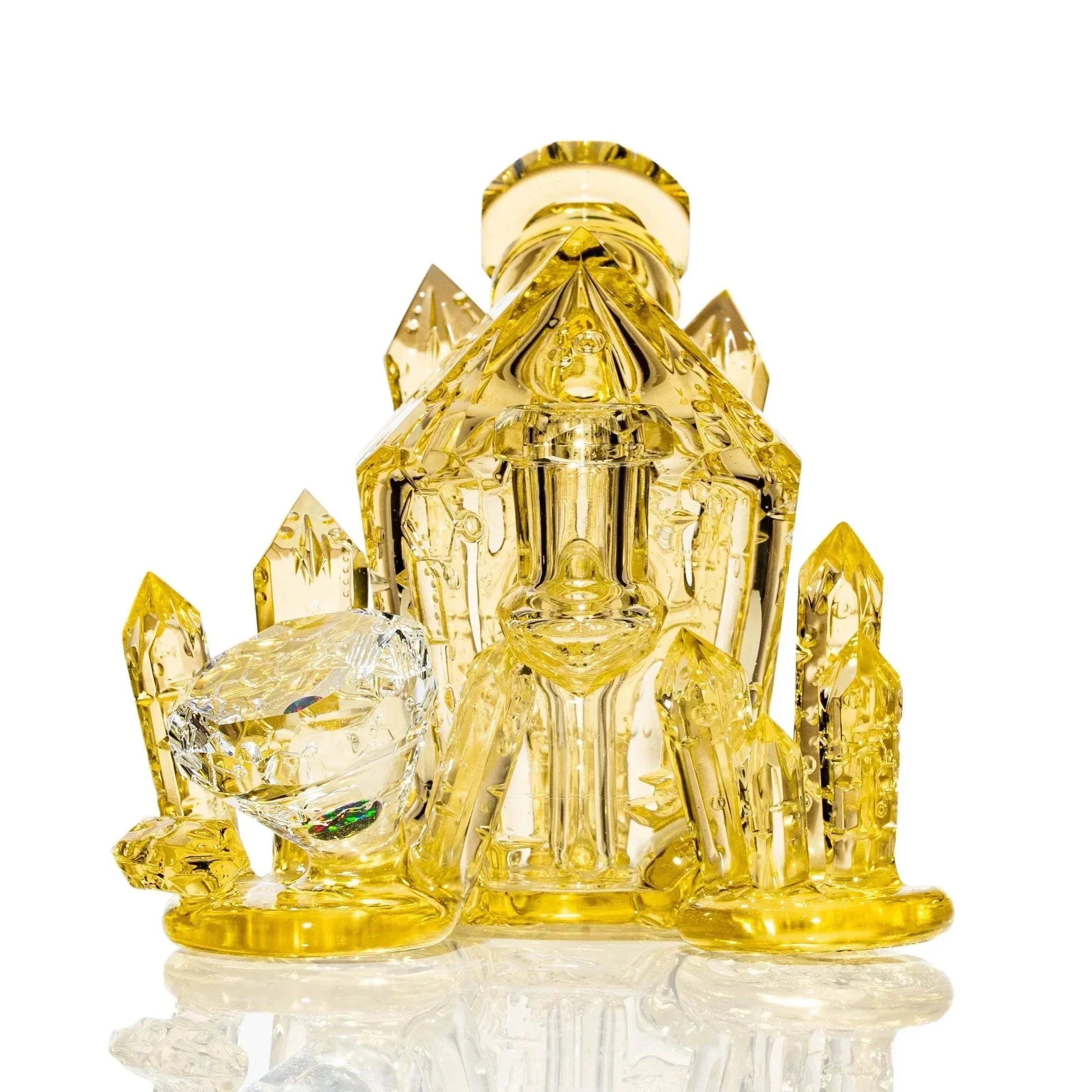 Yellow crystal-shaped glass water pipe with intricate details on a white background