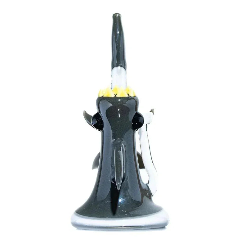 Handblown glass shark bubbler pipe with black and yellow detailing on white background