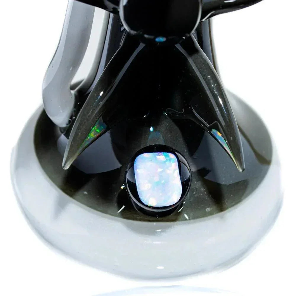 Close-up of iridescent opal embellishment on black borosilicate glass shark bubbler base