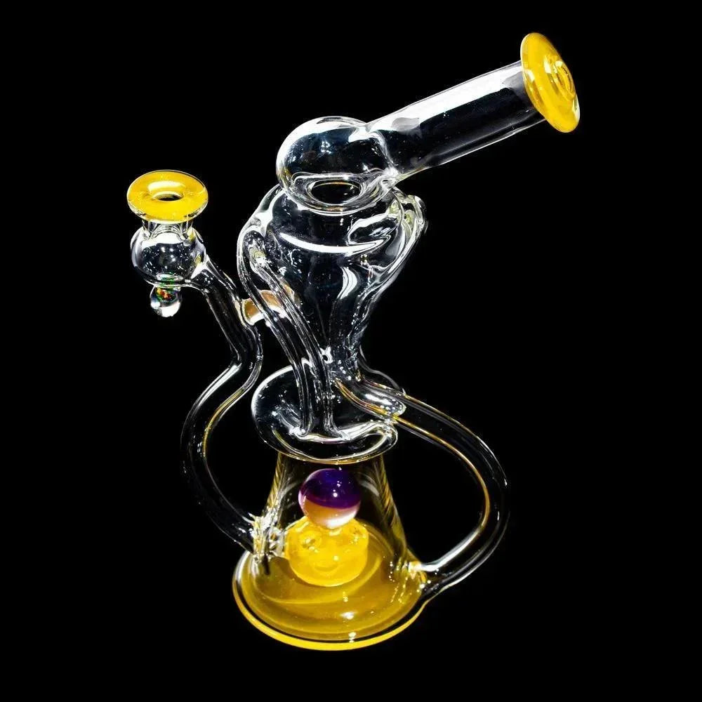 Dual uptake glass recycler water pipe with yellow accents and marble detail on black background.