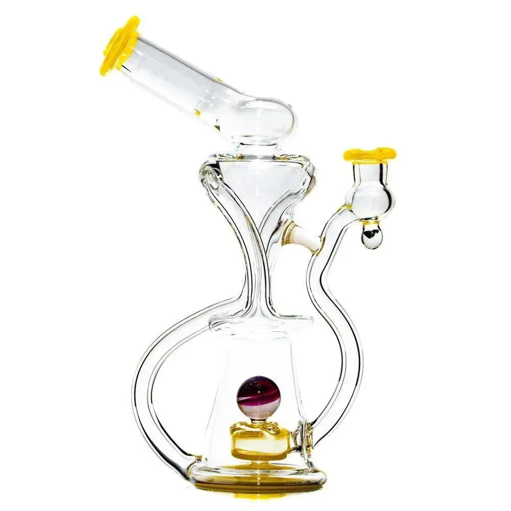 Clear glass recycler dab rig with yellow accents and colorful marble on white background