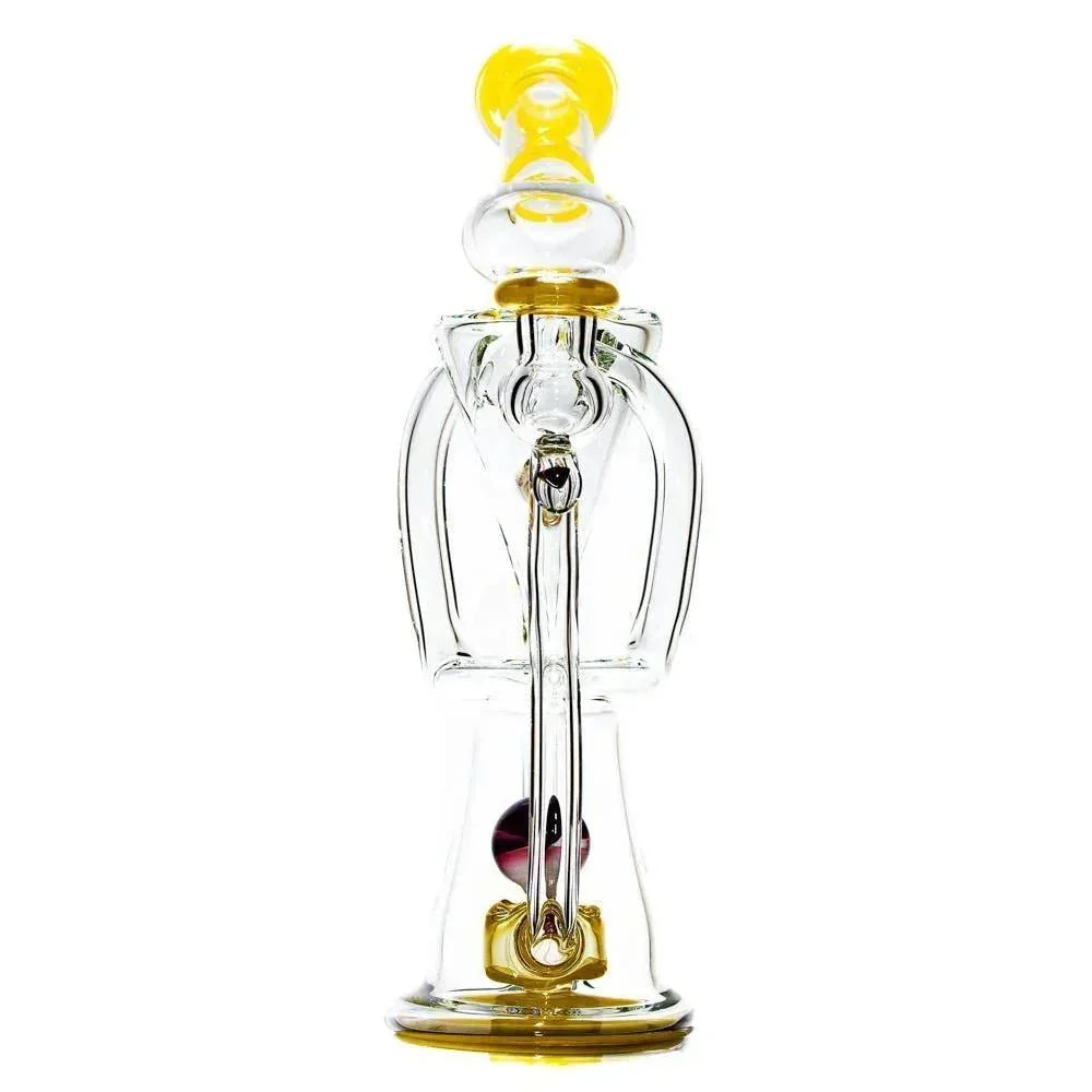 Clear glass dual uptake recycler rig with yellow accents and unique artistic design