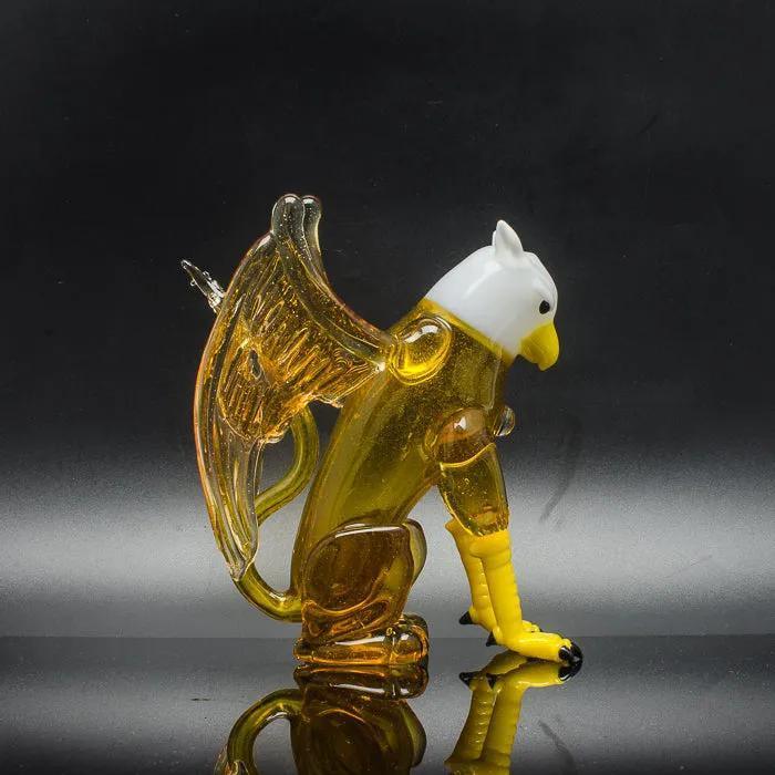 Amber glass eagle sculpture with white head and yellow beak, heady glass art piece