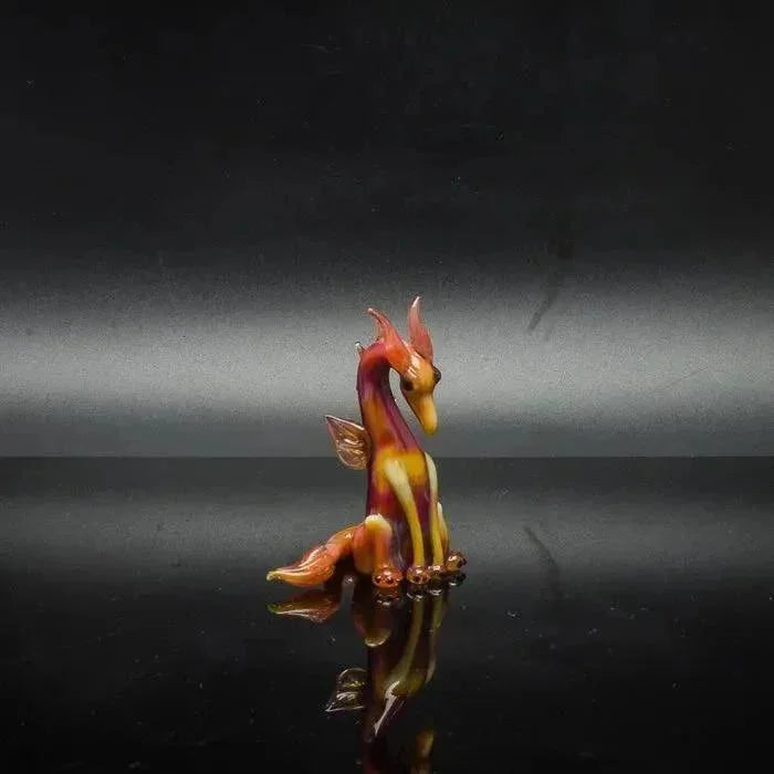 Vibrant glass dragon sculpture with fiery orange and yellow hues, perfect for heady glass collectors.