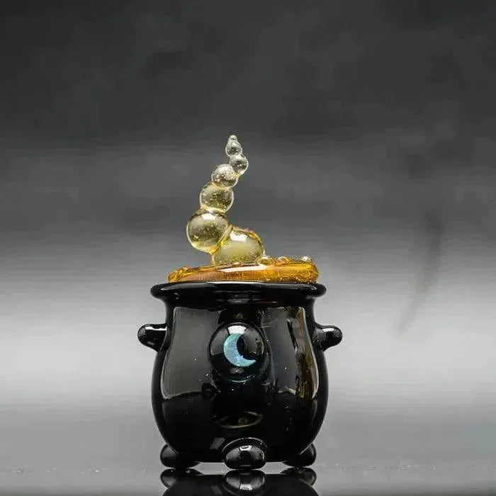 Black glass cauldron with glowing moon eye and amber bubbles, heady glass art piece