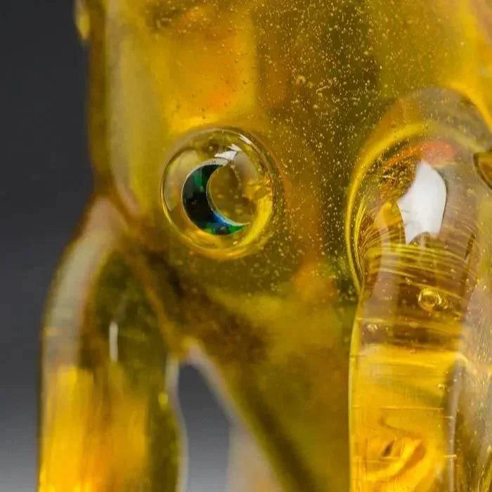 Amber glass elephant sculpture with iridescent eye detail, heady art glass collectible