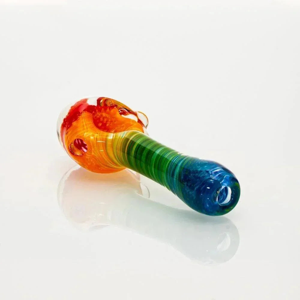 Rainbow frit glass spoon pipe with honeycomb design on a white background